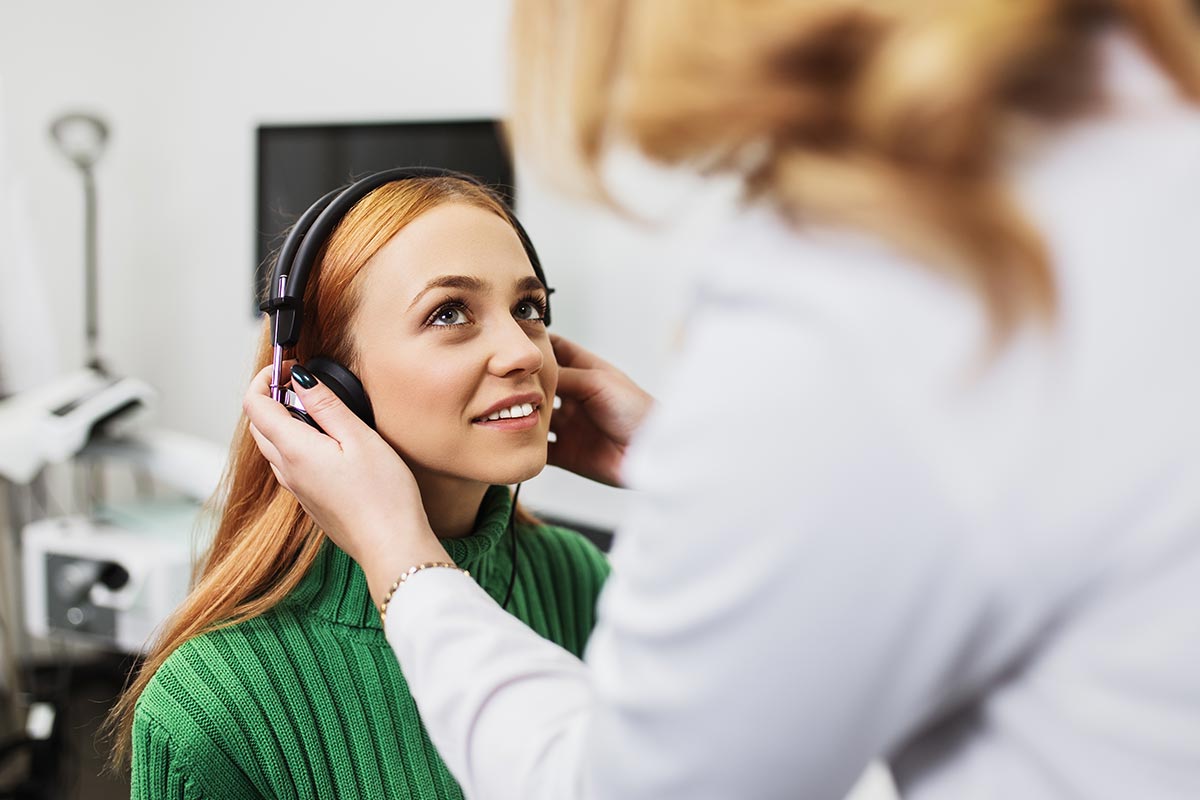 Patient undergoing a professional hearing assessment with headphones