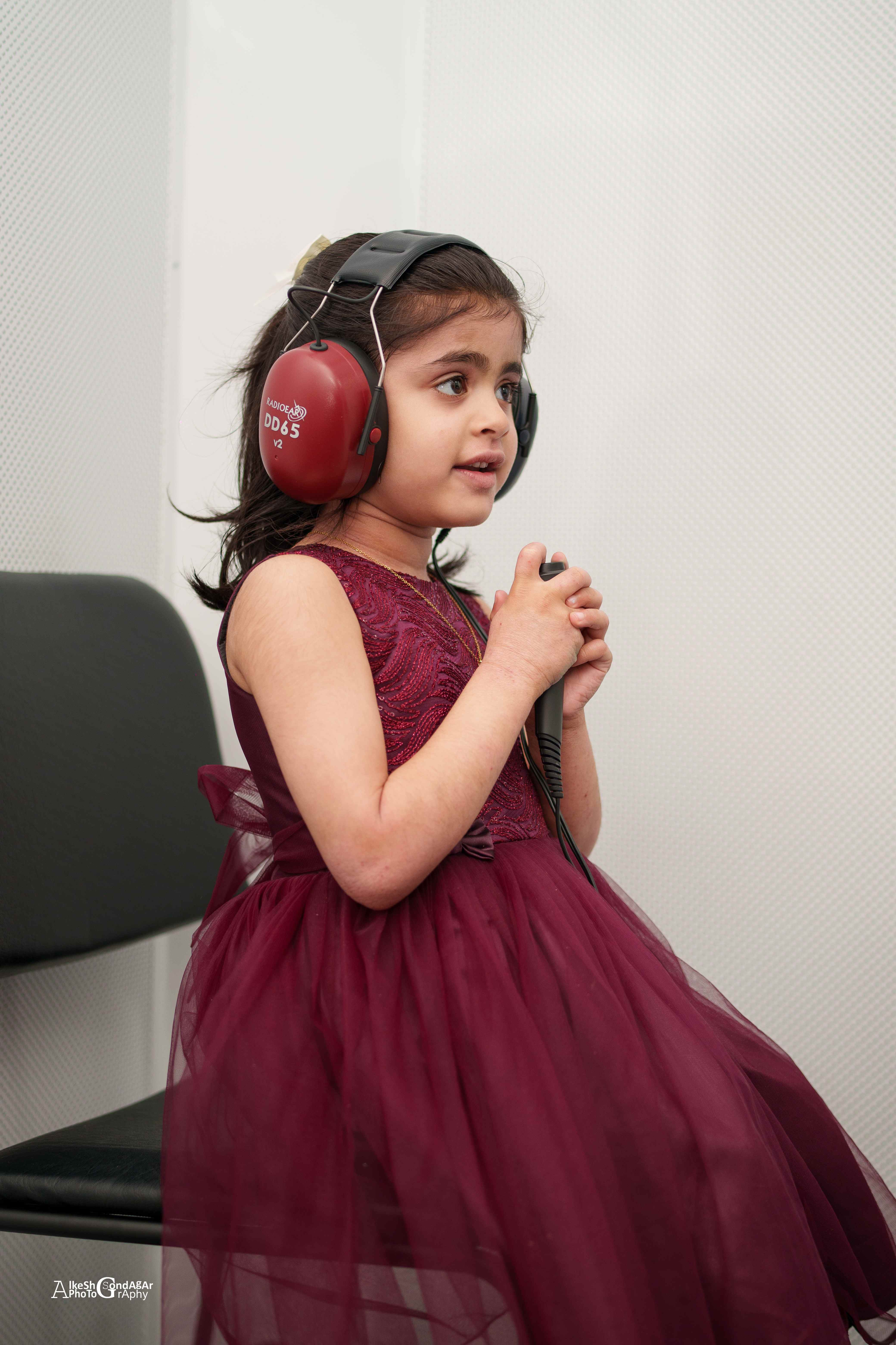 Young child wearing audiometry headphones during a paediatric hearing evaluation